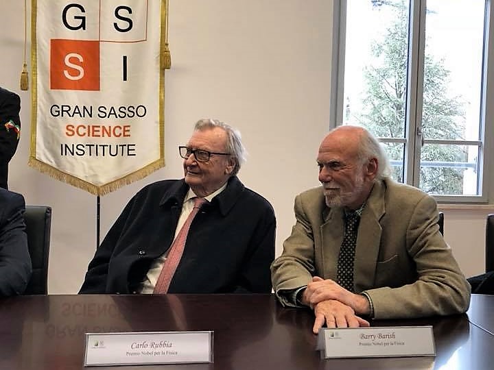 Carlo Rubbia and Barry Barish are pictured with branding for the Gran Sasso Science Institute.