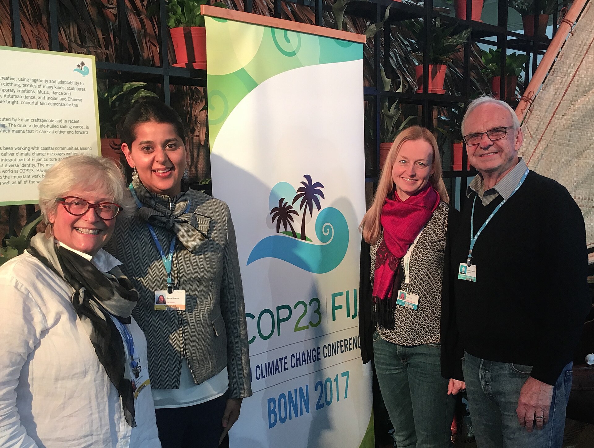 Four people attend the COP23 Fiji Climate Change Conference in Bonn, Germany, discussing important environmental issues.