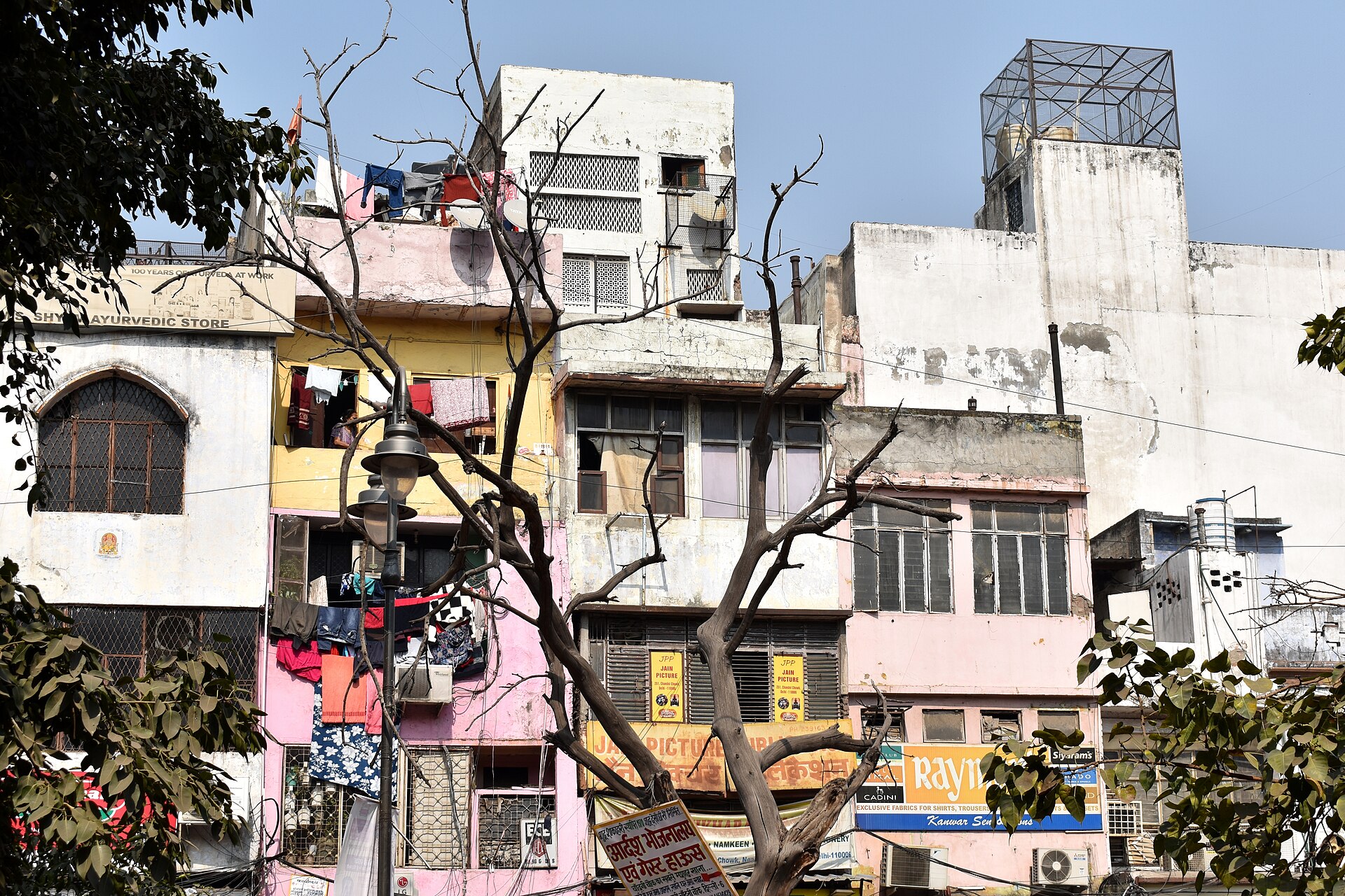 A densely packed cityscape shows colorful buildings and laundry drying on rooftops, illustrating the vibrant culture of.