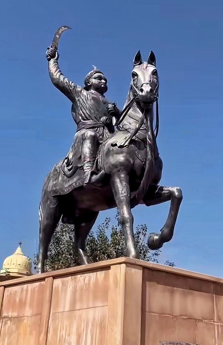A bronze equestrian statue shows Shivaji Maharaj with a raised sword, representing Indian history and culture.